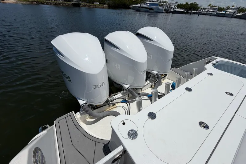 Slide: The Image of Triple Yamaha outboard engines on a 2009 Everglades 350LX boat docked by the water. - 15