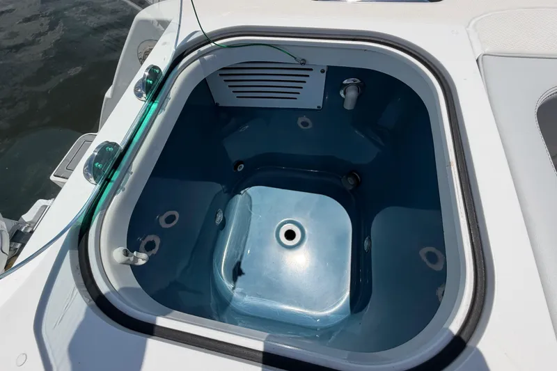 Slide: The Image of Livewell on 2009 Everglades 350LX boat, featuring a blue interior and water inlet. - 19