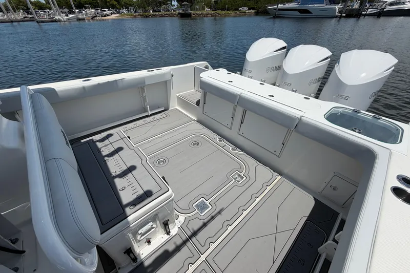 Slide: The Image of 2009 Everglades 350LX boat deck with Yamaha engines, docked by the water. - 21