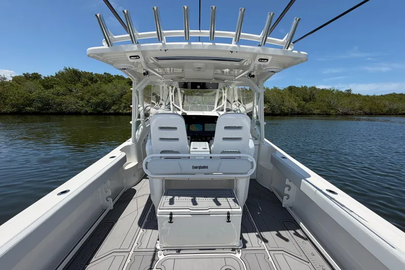 Slide: The Image of 2009 Everglades 350LX boat interior with seating and console on calm water. - 22