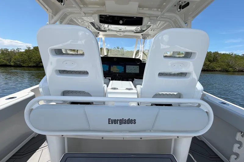 Slide: The Image of 2009 Everglades 350LX boat interior with dual white seats and navigation console. - 25