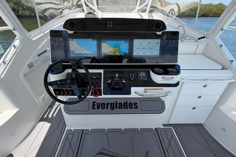 Slide: The Image of Cockpit of 2009 Everglades 350LX boat with dual navigation screens and steering wheel. - 27
