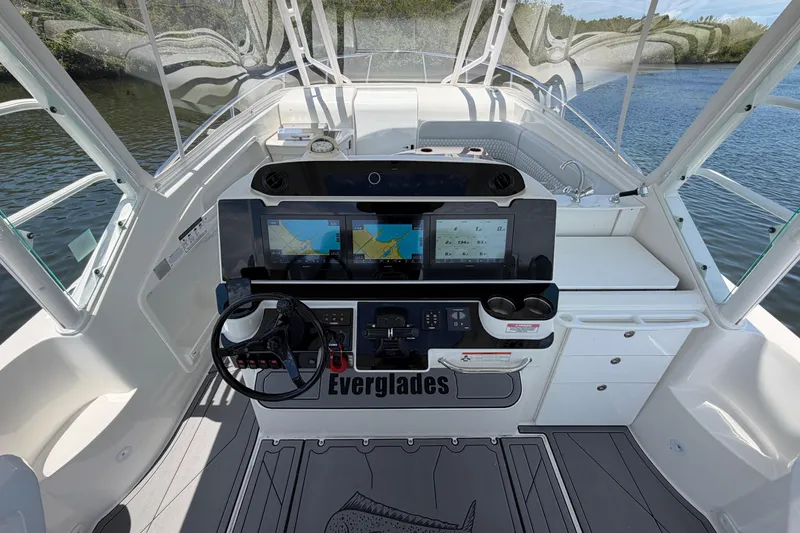 Slide: The Image of Cockpit of 2009 Everglades 350LX boat with navigation screens and steering wheel. - 28