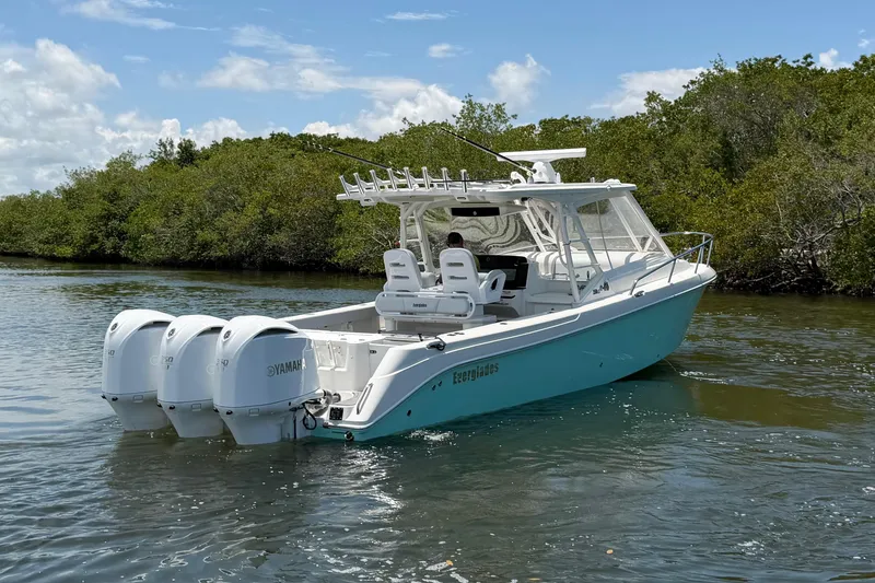 Slide: The Image of 2009 Everglades 350LX boat with triple Yamaha engines on a calm waterway. - 3