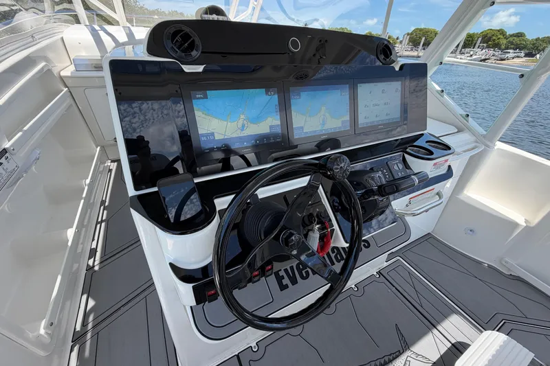 Slide: The Image of Cockpit of 2009 Everglades 350LX boat with advanced navigation displays and steering wheel. - 31