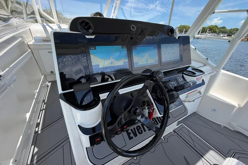 Slide: The Image of Cockpit of 2009 Everglades 350LX boat with advanced navigation displays and steering wheel. - 32