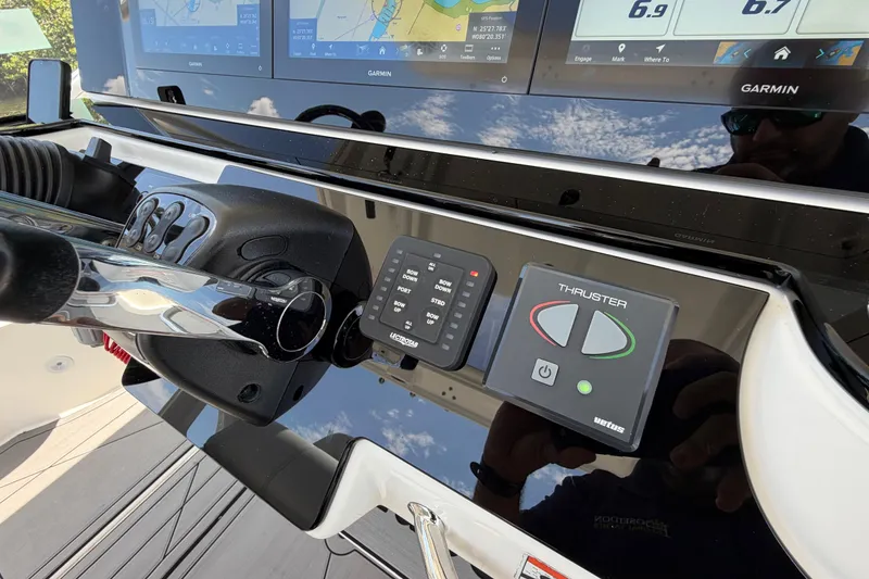 Slide: The Image of Control panel of a 2009 Everglades 350LX boat with Garmin displays and thruster controls. - 33