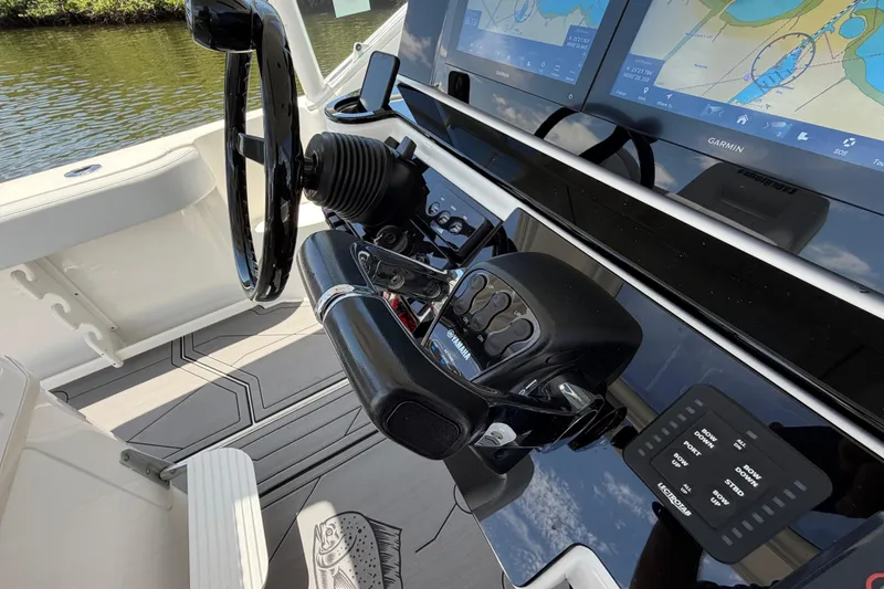 Slide: The Image of Control panel of a 2009 Everglades 350LX boat with Garmin navigation displays. - 34