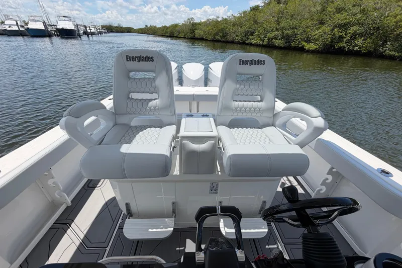 Slide: The Image of 2009 Everglades 350LX boat interior with luxurious seating on a calm waterway. - 38