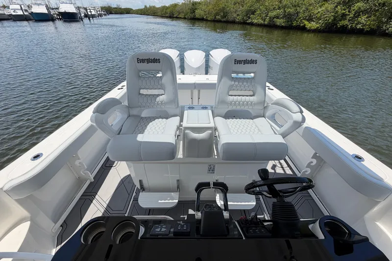 Slide: The Image of 2009 Everglades 350LX boat interior with dual captain's chairs on a calm waterway. - 39