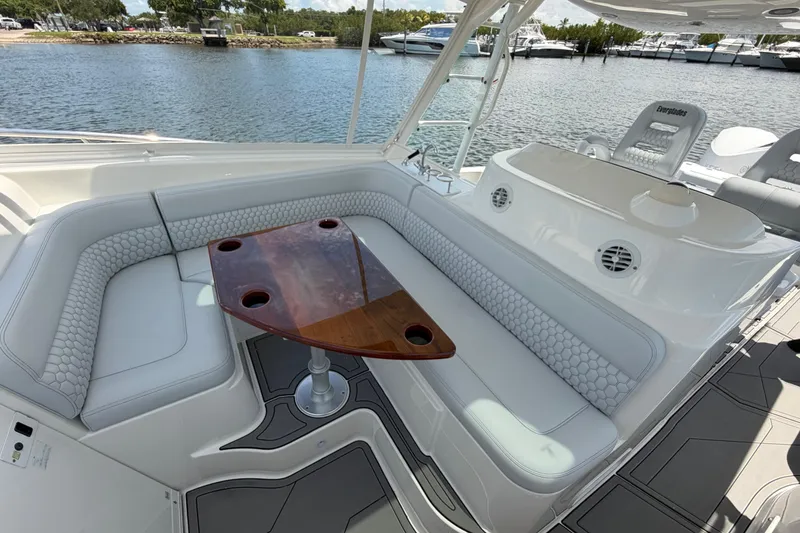 Slide: The Image of Luxurious seating area on a 2009 Everglades 350LX boat with a wooden table. - 48