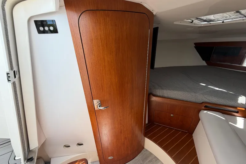 Slide: The Image of Interior cabin of 2009 Everglades 350LX boat with wooden door and cozy bed. - 55