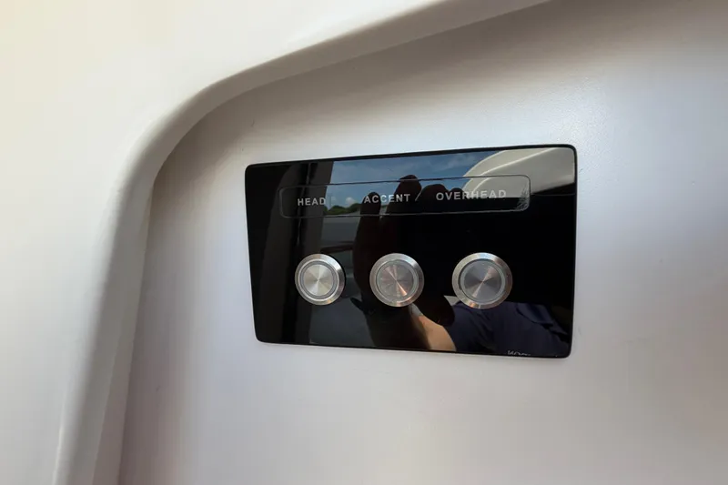 Slide: The Image of Control panel with three buttons on a 2009 Everglades 350LX boat. - 56
