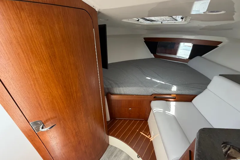 Slide: The Image of Interior cabin of 2009 Everglades 350LX boat with bed and seating area. - 60