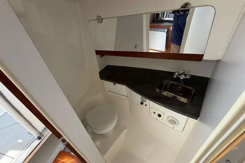 Slide: The Image of Compact bathroom in 2009 Everglades 350LX boat with sink, toilet, and mirror. - 61