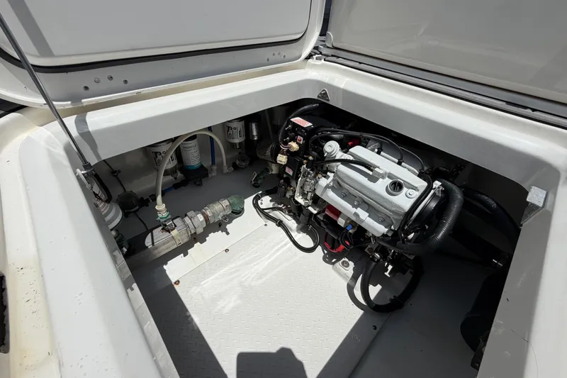 Slide: The Image of Engine compartment of a 2009 Everglades 350LX boat, showcasing mechanical components. - 63