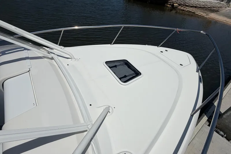 Slide: The Image of 2009 Everglades 350LX boat deck with railing, docked by calm water. - 68