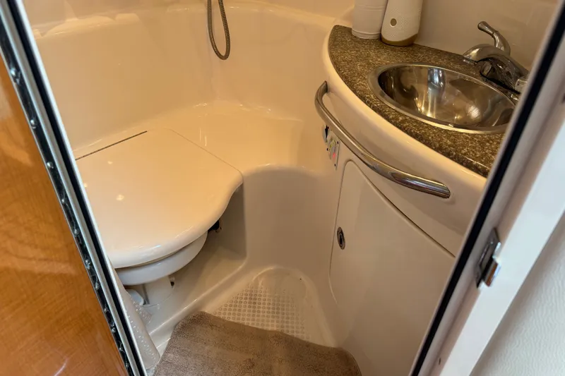 Slide: The Image of 2009 Chaparral Signature 330 bathroom with compact toilet and stainless steel sink. - 28