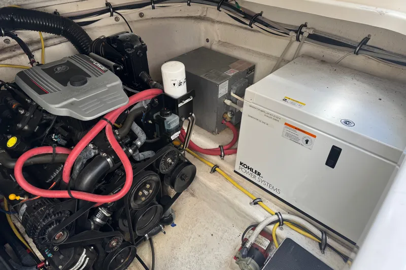 Slide: The Image of Engine compartment of 2009 Chaparral Signature 330 with Kohler power system and red hoses. - 37