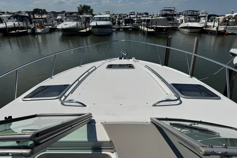 Slide: The Image of 2009 Chaparral Signature 330 yacht docked in a marina, surrounded by other boats. - 19