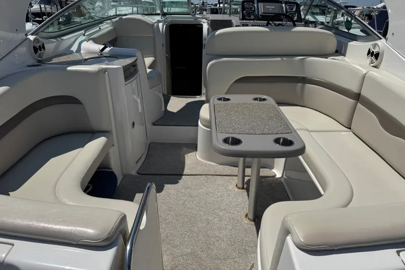 Slide: The Image of 2009 Chaparral Signature 330 boat interior with plush seating and table setup. - 7