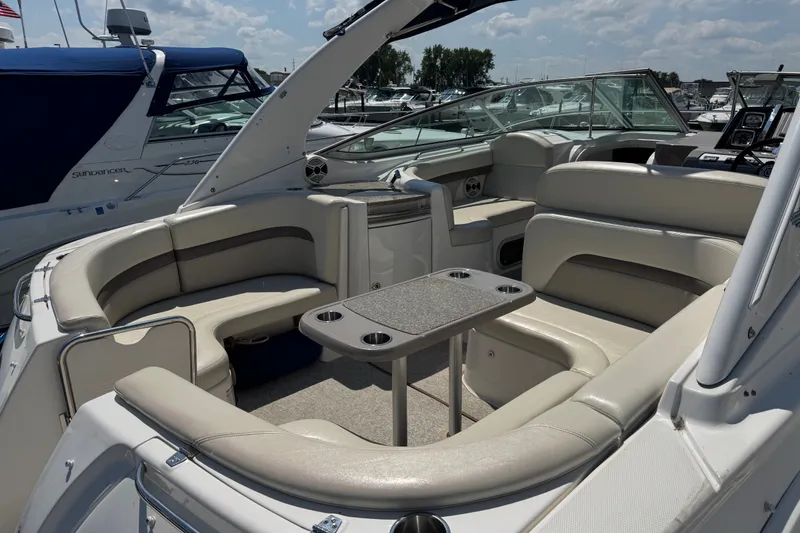 Slide: The Image of 2009 Chaparral Signature 330 boat interior with seating and table, docked at marina. - 5