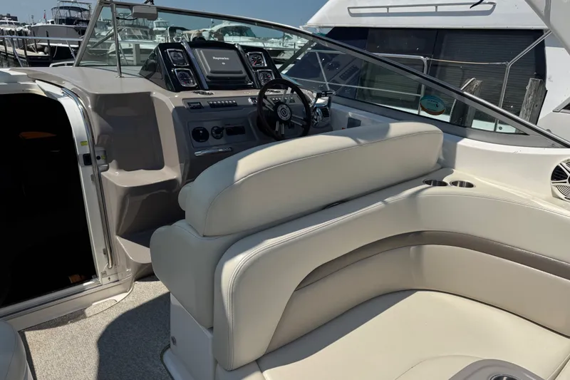 Slide: The Image of 2009 Chaparral Signature 330 boat interior with helm, steering wheel, and seating area. - 11