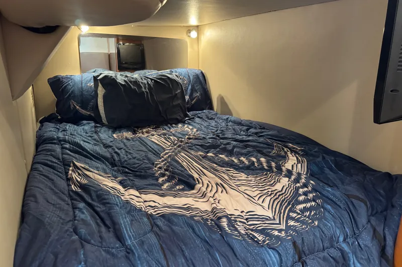 Slide: The Image of Cozy cabin bed with anchor-themed bedding in 2009 Chaparral Signature 330 yacht. - 32