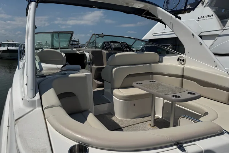 Slide: The Image of 2009 Chaparral Signature 330 boat interior with seating and table, docked at marina. - 6