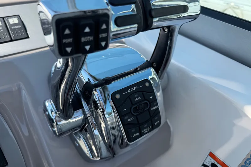 Slide: The Image of Control panel of a 2009 Chaparral Signature 330 boat, featuring throttle and navigation controls. - 15