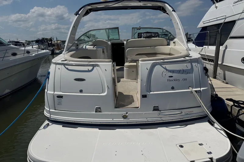 Slide: The Image of 2009 Chaparral Signature 330 boat docked, rear view with open seating area. - 1