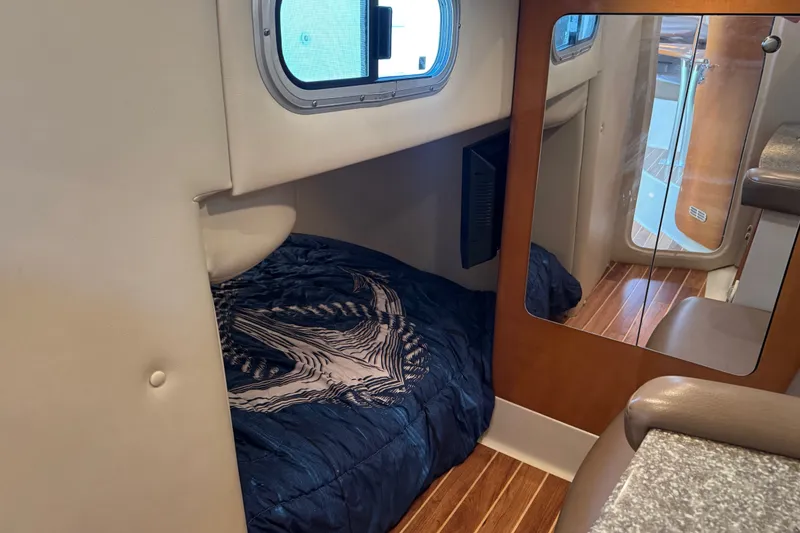 Slide: The Image of 2009 Chaparral Signature 330 cabin interior with cozy bed and wooden flooring. - 33