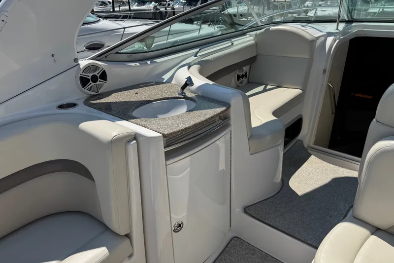 Slide: The Image of 2009 Chaparral Signature 330 boat interior with seating, sink, and speaker system. - 10
