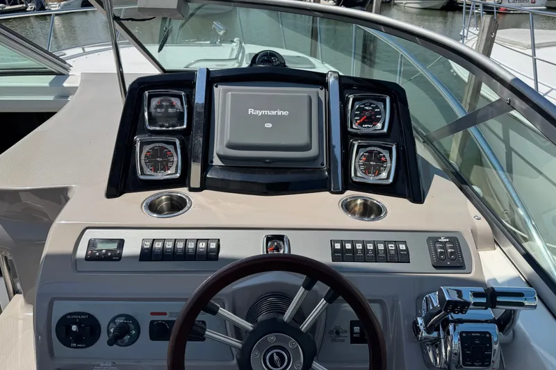 Slide: The Image of 2009 Chaparral Signature 330 helm with Raymarine navigation system and control panel. - 14