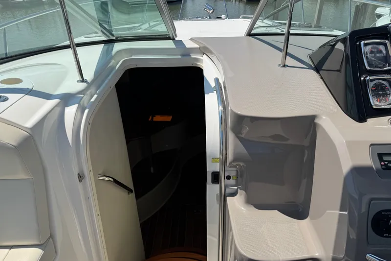Slide: The Image of 2009 Chaparral Signature 330 boat interior entrance with dashboard and open cabin door. - 18