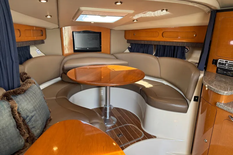 Slide: The Image of Luxurious 2009 Chaparral Signature 330 yacht interior with cozy seating and elegant wood finishes. - 25