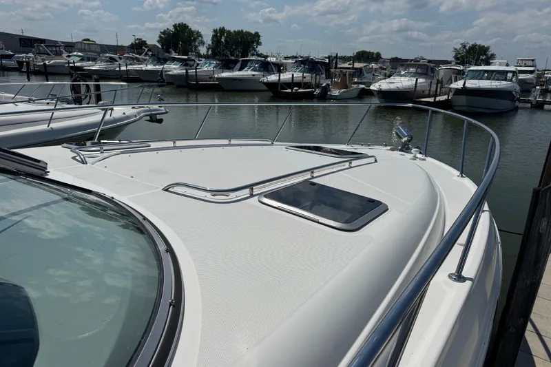 Slide: The Image of 2009 Chaparral Signature 330 yacht docked at a marina under a partly cloudy sky. - 2