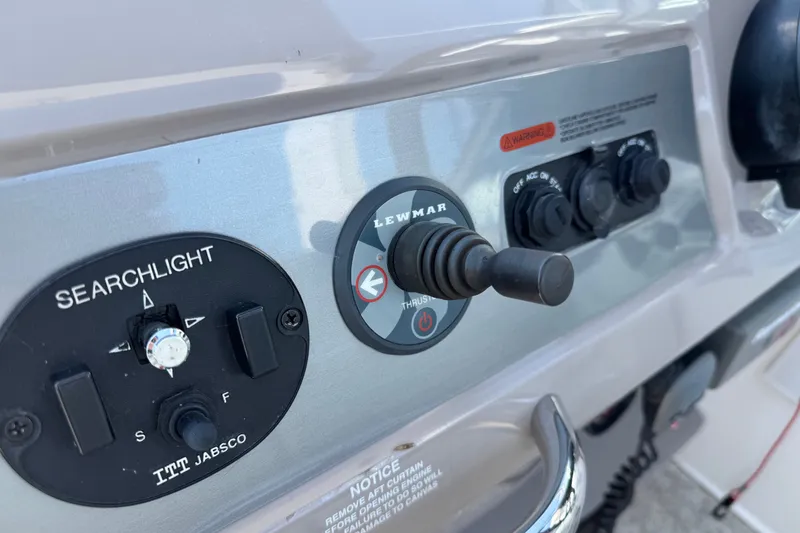Slide: The Image of Control panel of a 2009 Chaparral Signature 330 boat featuring searchlight and thruster controls. - 17