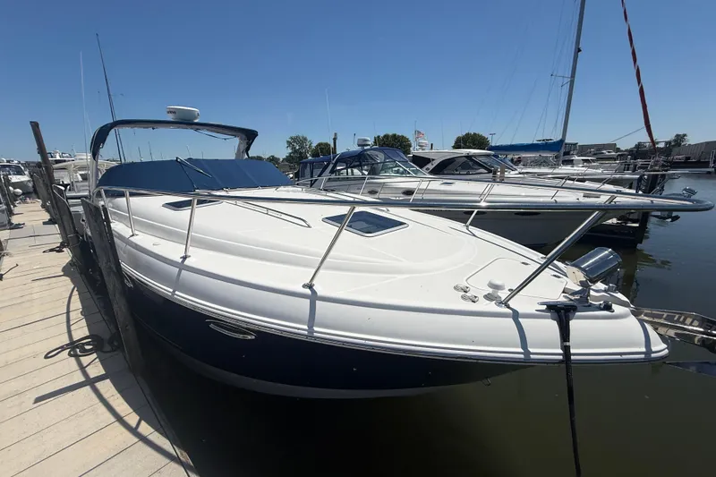 The Image of 2009 Chaparral Signature 330 boat docked at marina under clear blue sky. - 1