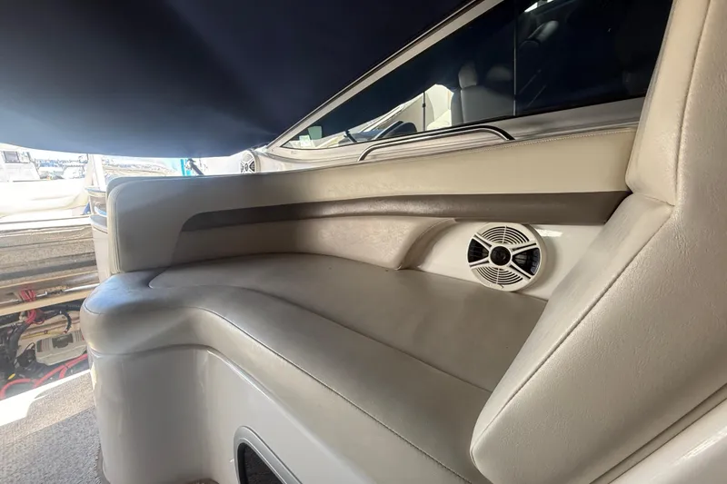 Slide: The Image of 2009 Chaparral Signature 330 boat interior with cushioned seating and speaker. - 12