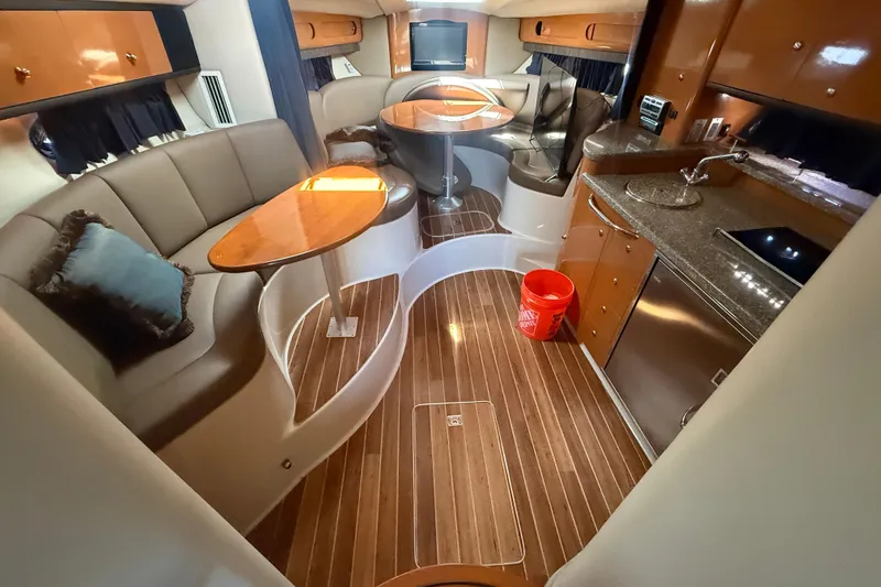 Slide: The Image of Luxurious interior of 2009 Chaparral Signature 330 yacht with elegant seating and kitchenette. - 14