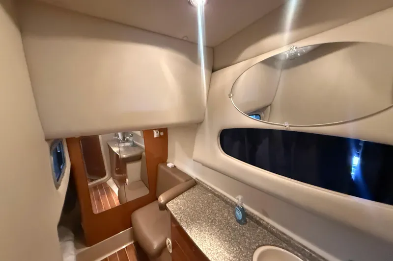 Slide: The Image of Interior of 2009 Chaparral Signature 330 yacht, featuring a modern bathroom with mirror and sink. - 18