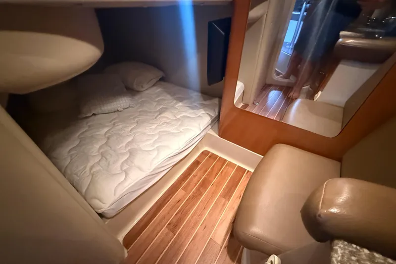 Slide: The Image of 2009 Chaparral Signature 330 cabin interior with cozy bed and wooden flooring. - 19