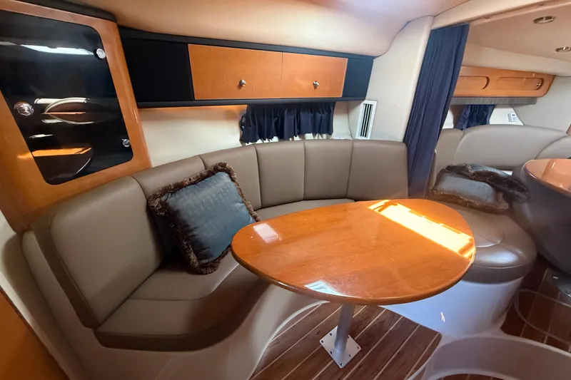 Slide: The Image of 2009 Chaparral Signature 330 interior with cozy seating and wooden table. - 20