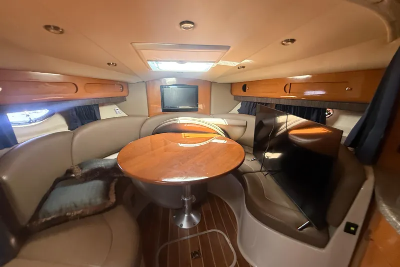 Slide: The Image of Luxurious interior of 2009 Chaparral Signature 330 yacht with cozy seating and wooden table. - 21