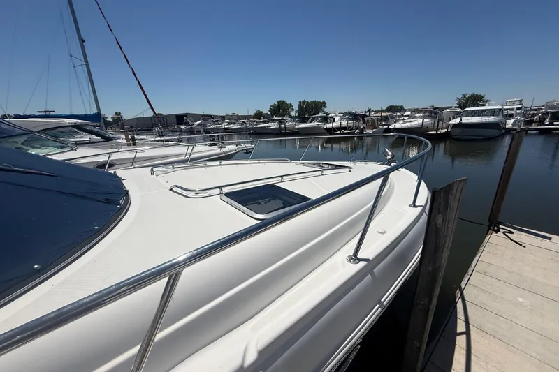 Slide: The Image of 2009 Chaparral Signature 330 docked at a marina under clear blue skies. - 4