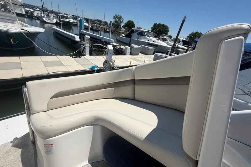 Slide: The Image of 2009 Chaparral Signature 330 boat interior with beige seating at marina. - 5