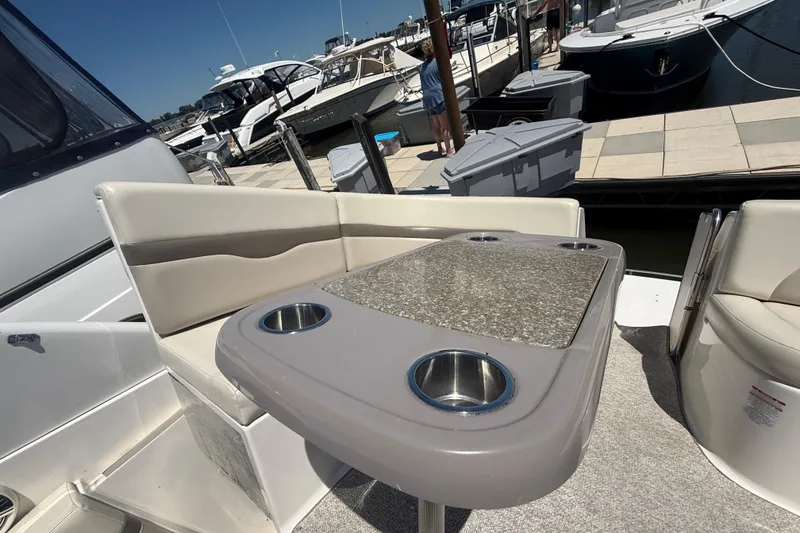 Slide: The Image of 2009 Chaparral Signature 330 boat interior with seating and table at marina. - 6