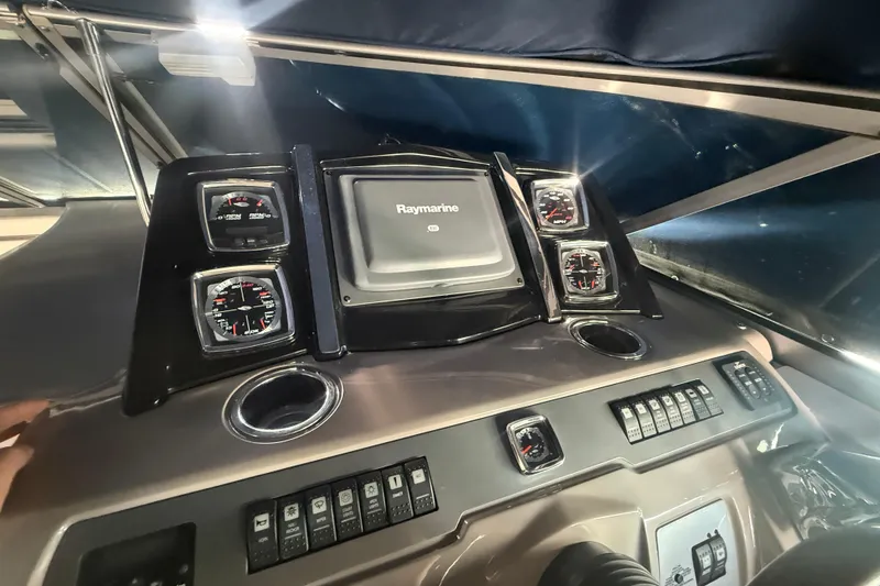 Slide: The Image of 2009 Chaparral Signature 330 dashboard with Raymarine display and gauges. - 9