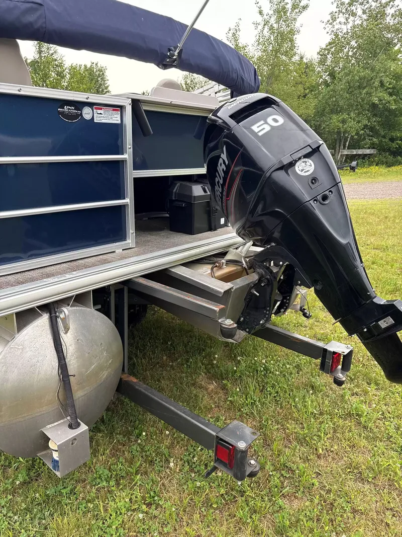 Slide: The Image of A 2016 Sylvan MIR 8520 CNF with a Mercury 50 HP outboard motor on grass. - 8